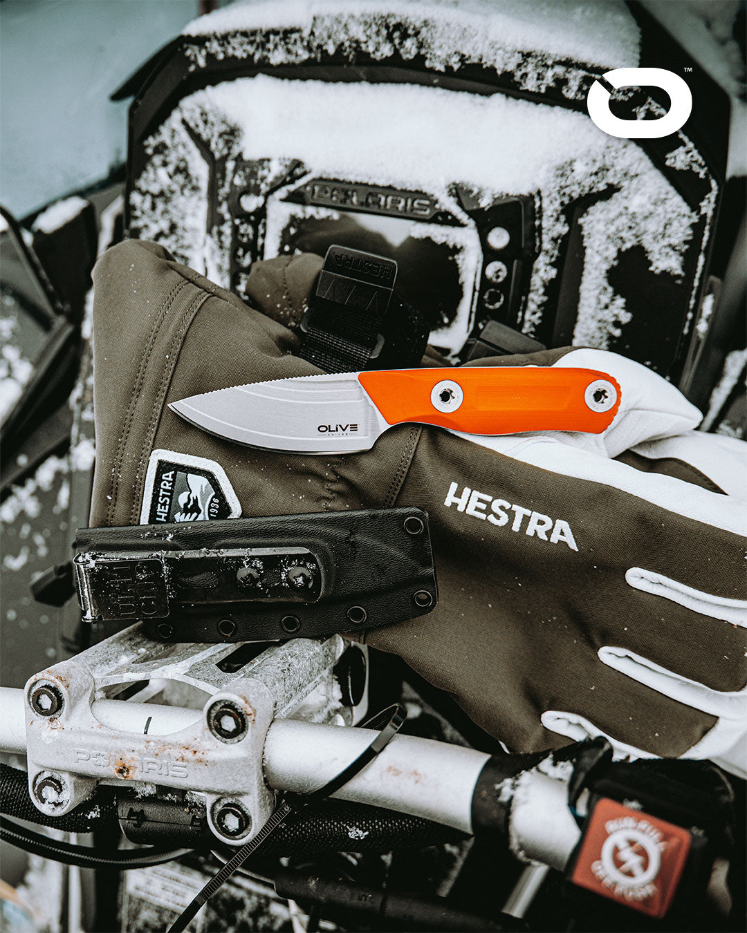 Olive Knives VENARI compact EDC fixed blade knife, Elmax steel — lifestyle, with snowy motorcycle gear