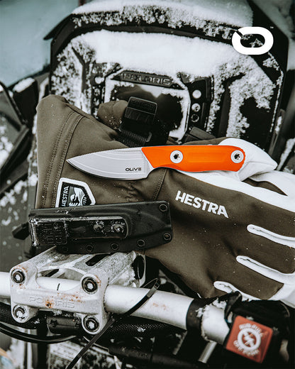 Olive Knives VENARI compact EDC fixed blade knife, Elmax steel — lifestyle, with snowy motorcycle gear