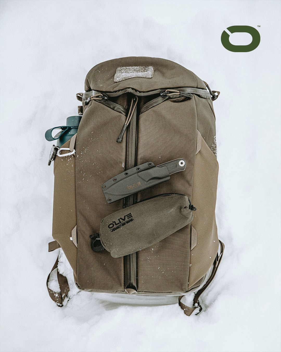 Olive Knives VENARI compact EDC fixed blade knife, Elmax steel — lifestyle, clipped to a backpack in the snow
