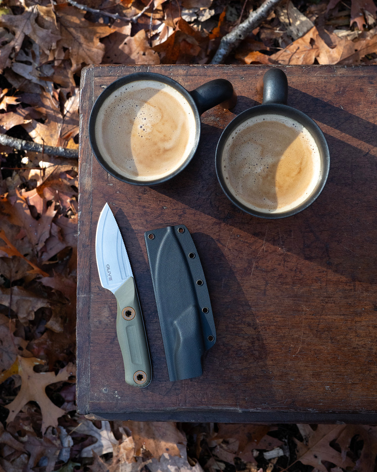 Olive Knives VENARI compact EDC fixed blade knife, Elmax steel — lifestyle, camp coffee flatlay